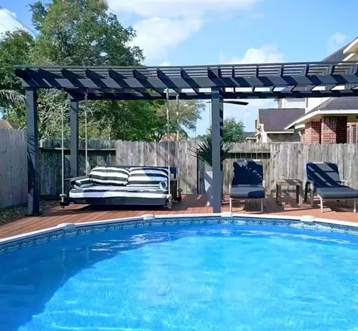 a view of a backyard with couches with wooden floor
