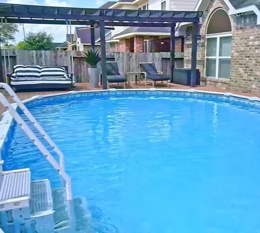 a view of swimming pool with seating space
