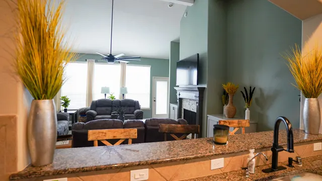 a kitchen with stainless steel appliances granite countertop a sink dishwasher a refrigerator with wooden cabinets