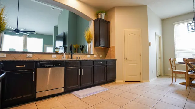 a bathroom with a granite countertop sink a mirror and a bathtub