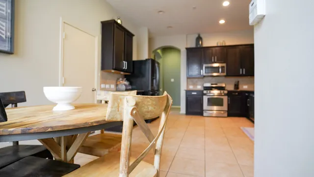 a kitchen with stainless steel appliances kitchen island granite countertop a refrigerator and microwave