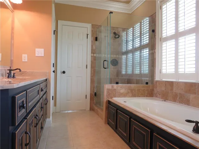 a bath room with a sink and a bath tub