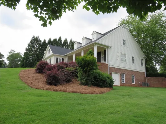 a front view of house with yard and green space