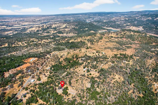 an aerial view of a houses with a yard