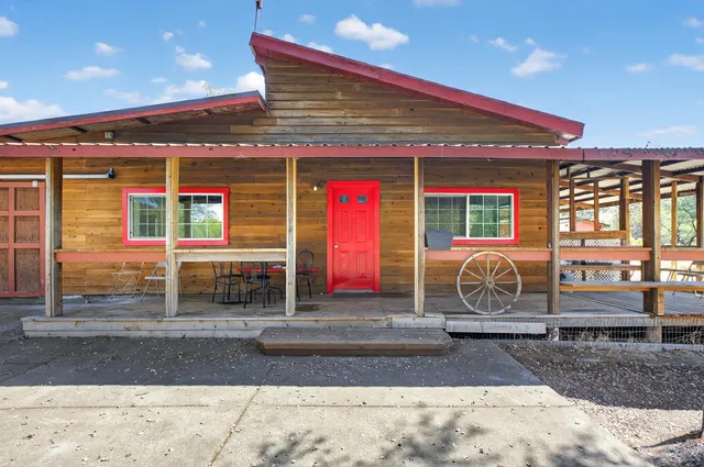 a view of a house with a yard and roof