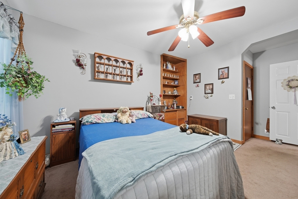 436 Franklin Road Fitchburg, MA 01420 - Photo 14 of 41 a bedroom with a bed and a chandelier