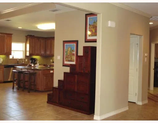 a kitchen with a refrigerator and a stove top oven