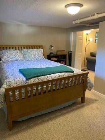 599 Union Street Braintree, MA 02184 - Photo 15 of 17 a bed sitting in a room next to a window