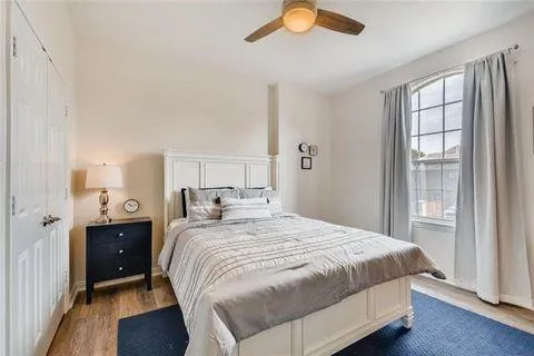 a bedroom with a bed and a window