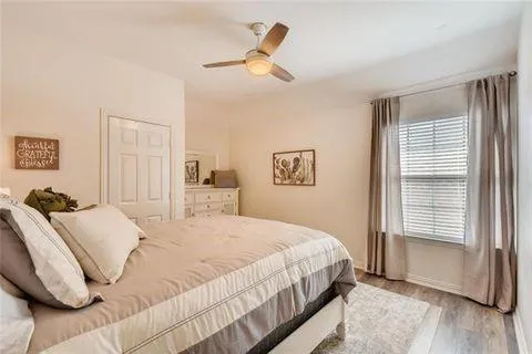 a bedroom with a bed and a window