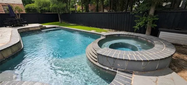 a view of swimming pool with a yard in back