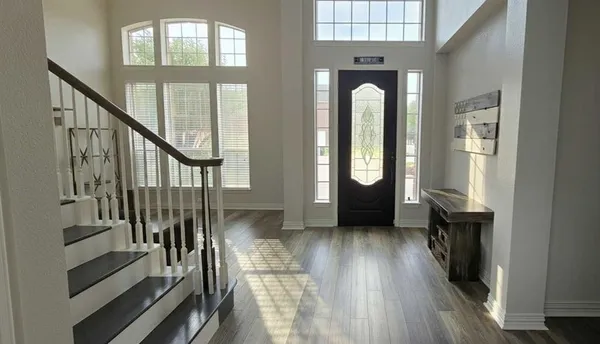 a view of entryway and hall with wooden floor