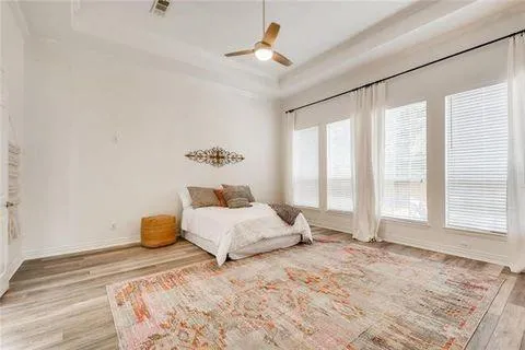 a spacious bedroom with a bed and a window