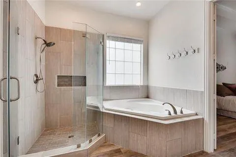 a bathroom with a bathtub and shower