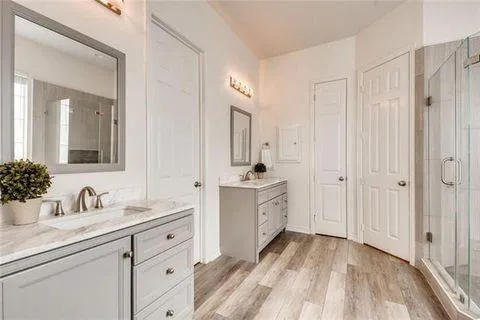 a spacious bathroom with a double vanity sink mirror and