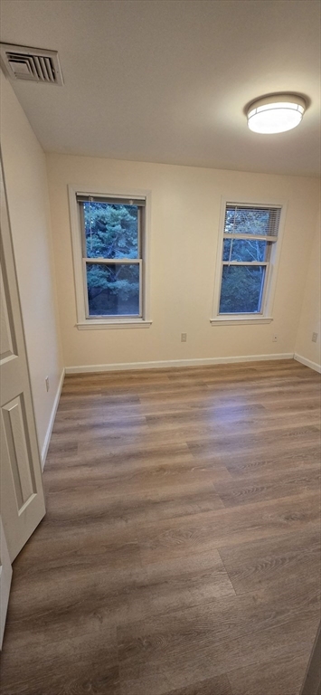 403 South Main Street, Unit 1 Sharon, MA 02067 - Photo 10 of 16 a view of an empty room with wooden floor