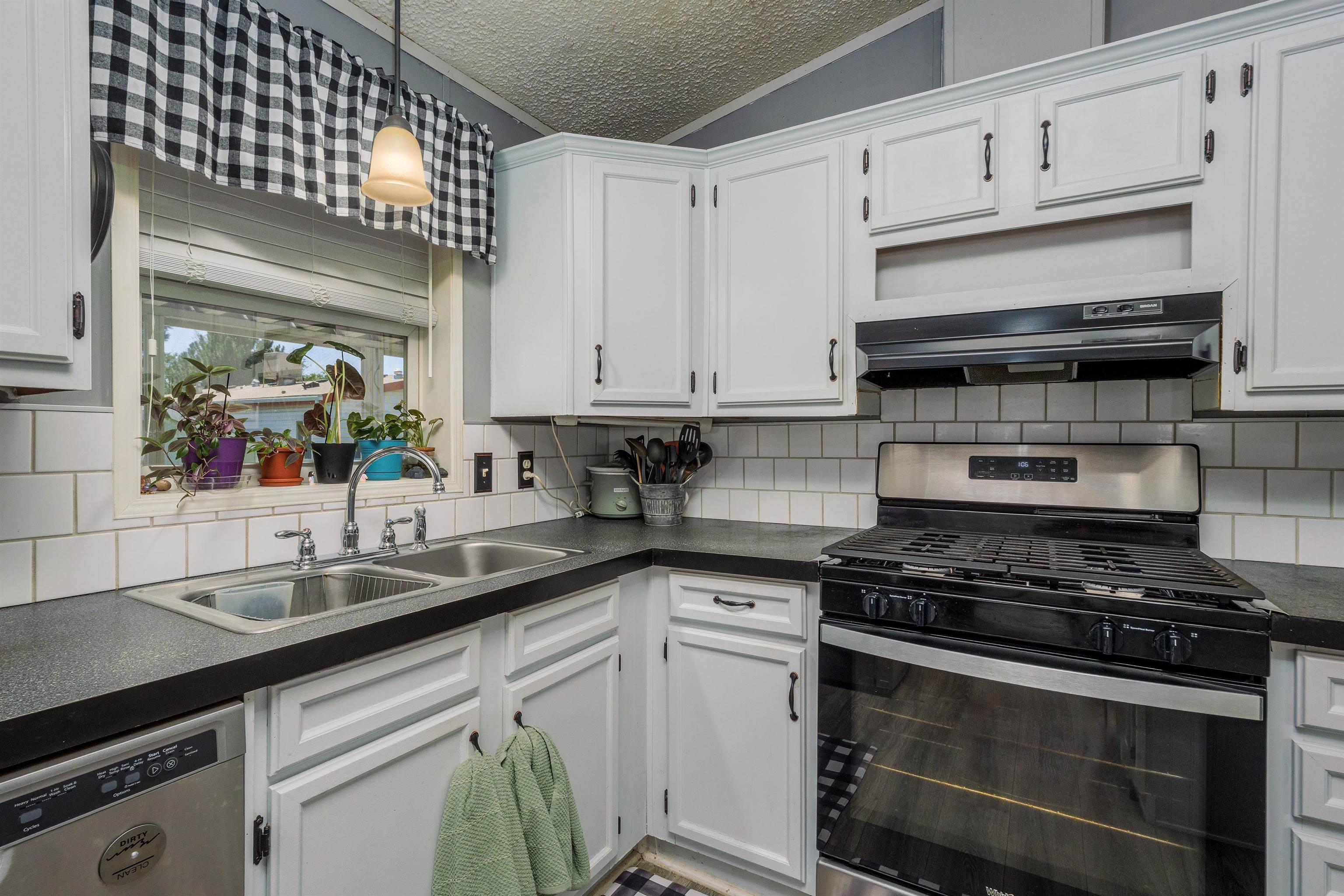 435 32 Road, Unit 705 Clifton, CO 81520 - Photo 11 of 25 a kitchen with white cabinets and appliances