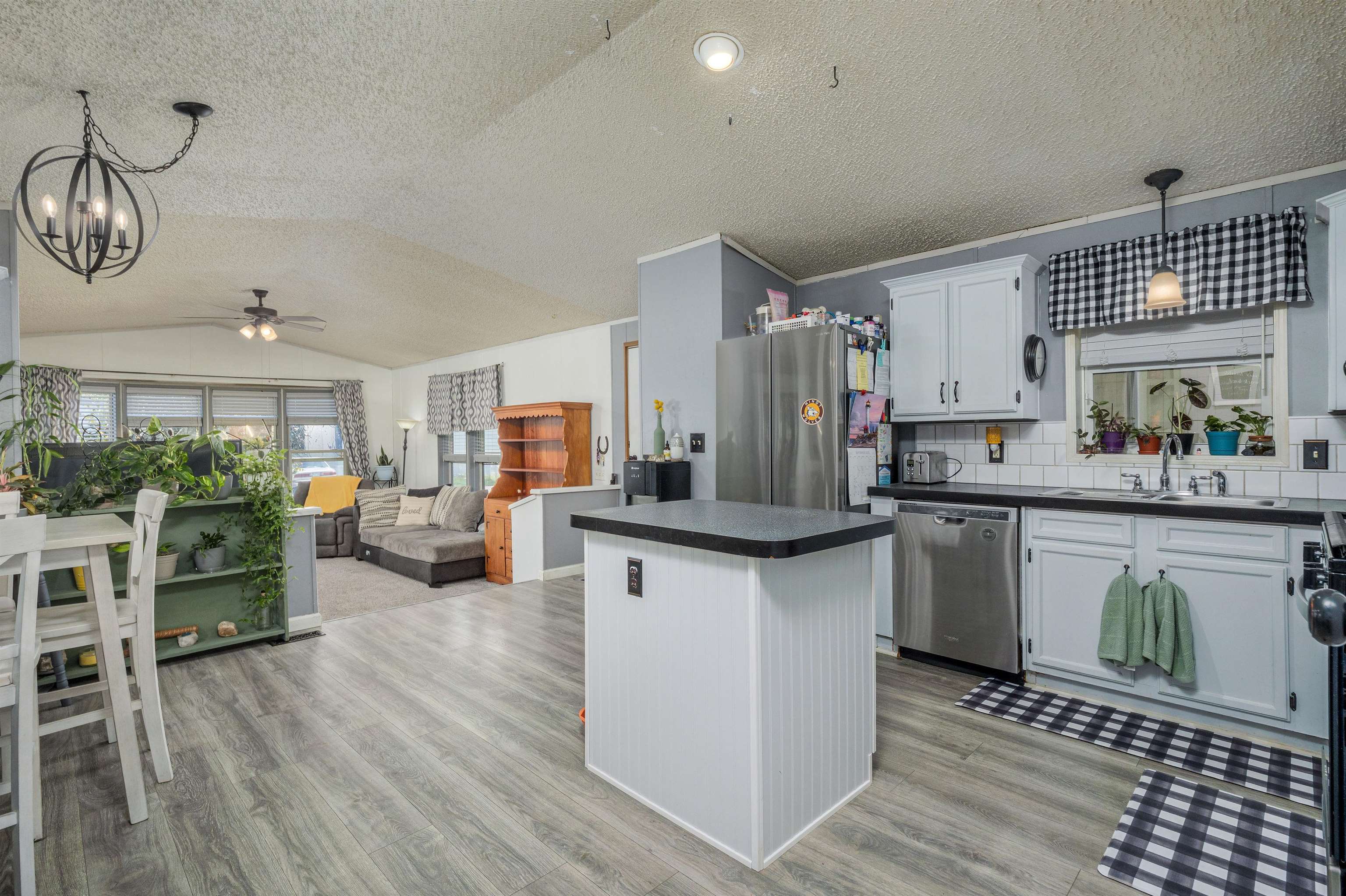 435 32 Road, Unit 705 Clifton, CO 81520 - Photo 15 of 25 a kitchen with stainless steel appliances a kitchen island hardwood floor sink stove dining table and chairs