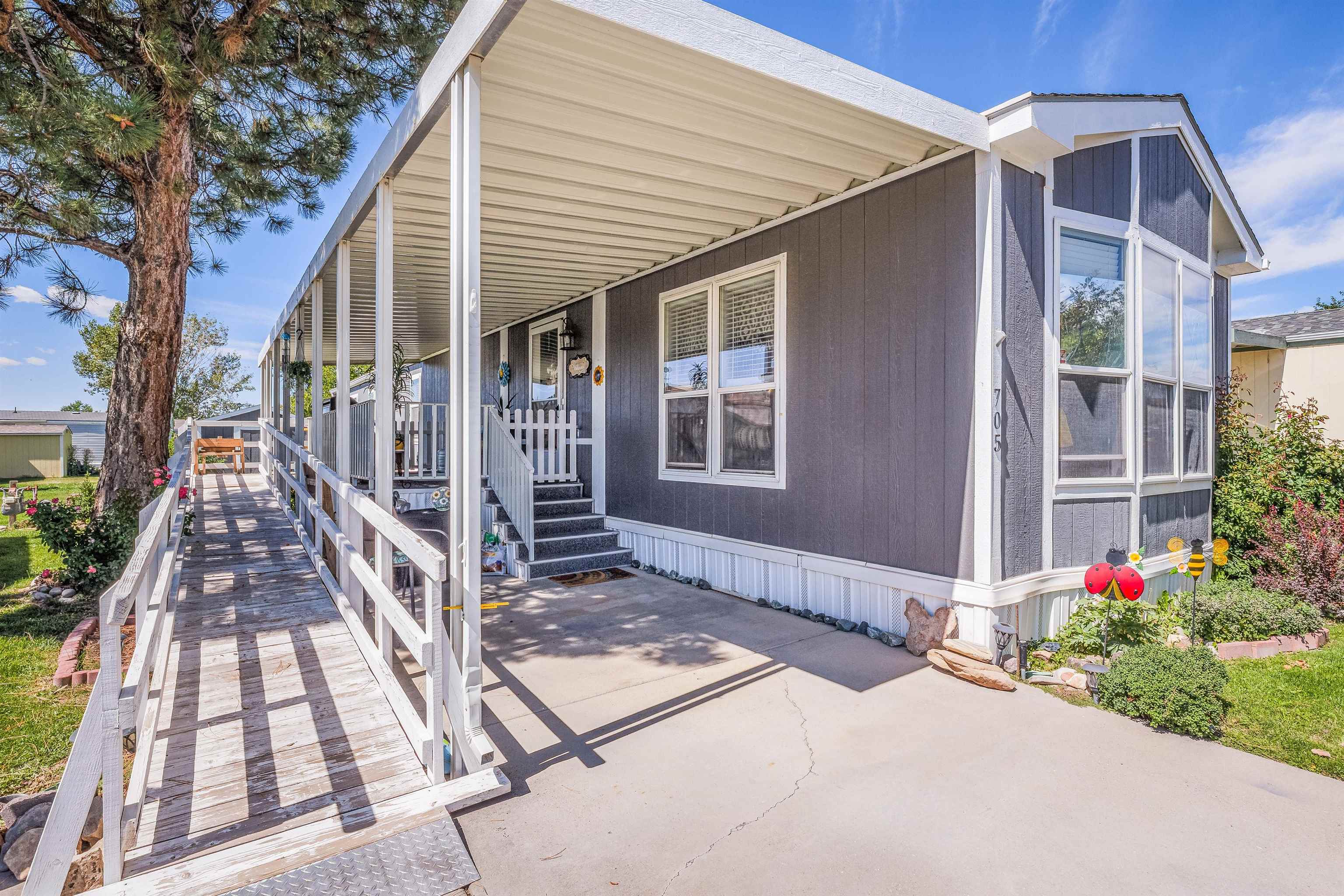 435 32 Road, Unit 705 Clifton, CO 81520 - Photo 2 of 25 a front view of a house with a porch