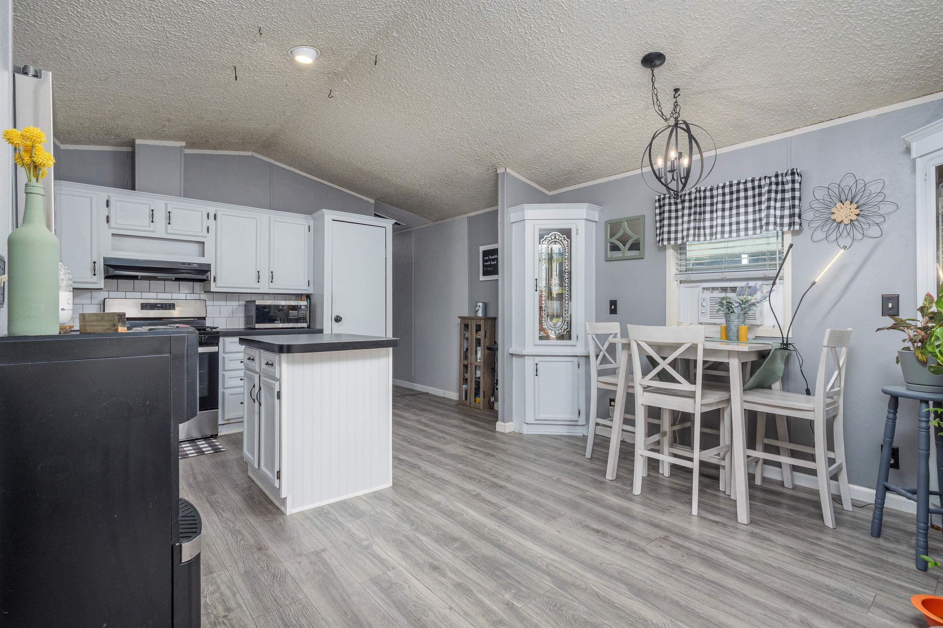 435 32 Road, Unit 705 Clifton, CO 81520 - Photo 9 of 25 a kitchen with stainless steel appliances granite countertop a refrigerator a stove top oven a sink dishwasher and white cabinets with wooden floor