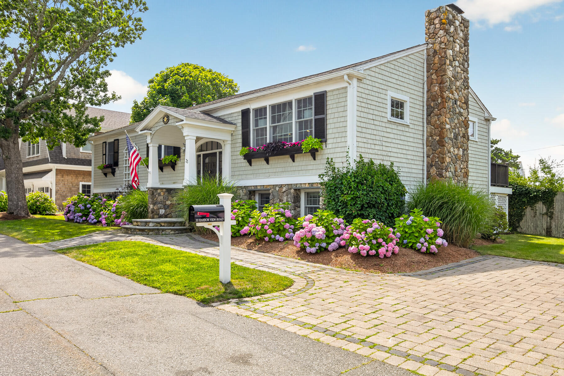33 Harbor View Road Harwich Port, MA 02646 - Photo 2 of 50 a front view of house with yard and flowers around