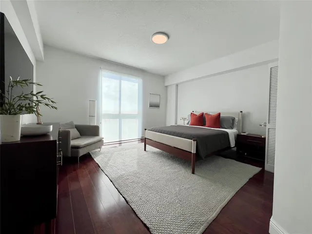 a bedroom with a bed and a flat screen tv