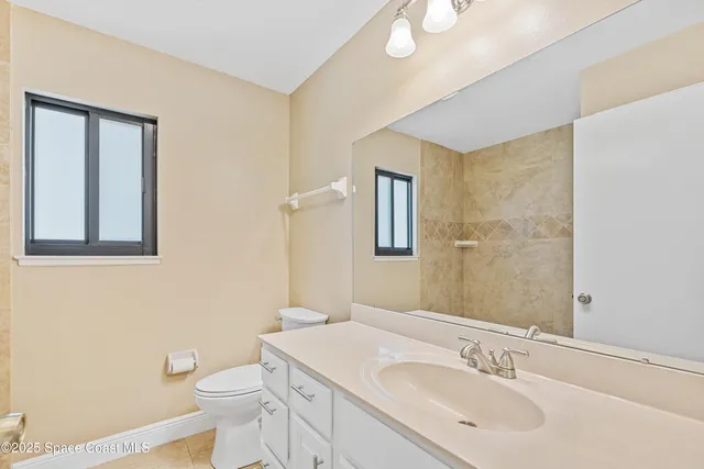 a bathroom with a sink toilet and mirror