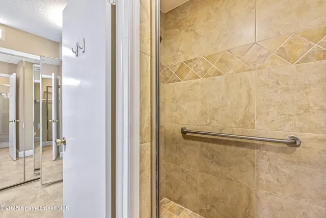 a bathroom with a glass shower door