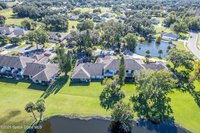 an aerial view of residential houses with swimming pool and outdoor space