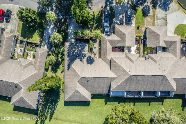 an aerial view of a house with a yard