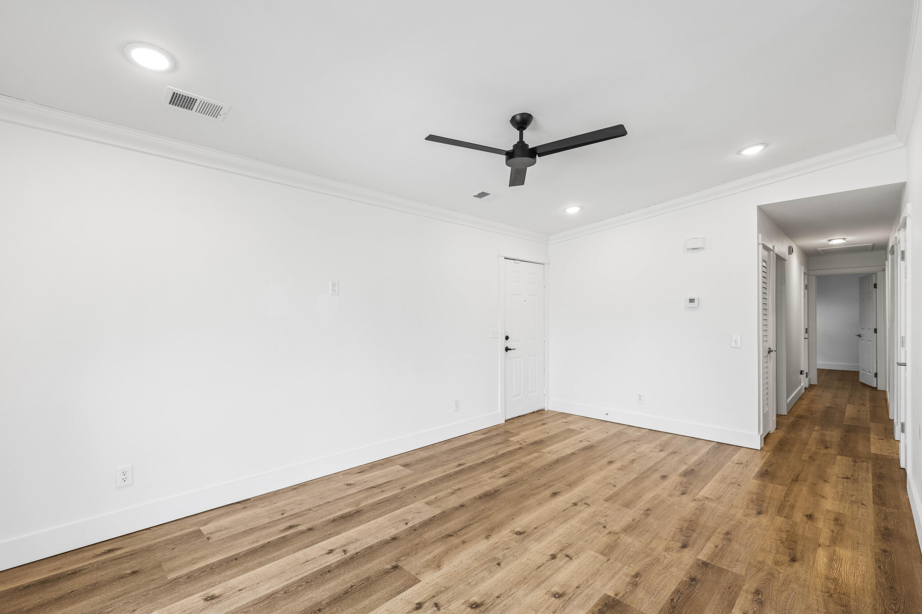 230 Plantation Way Santa Rosa Beach, FL 32459 - Photo 11 of 29 a view of a big room with wooden floor and a ceiling fan