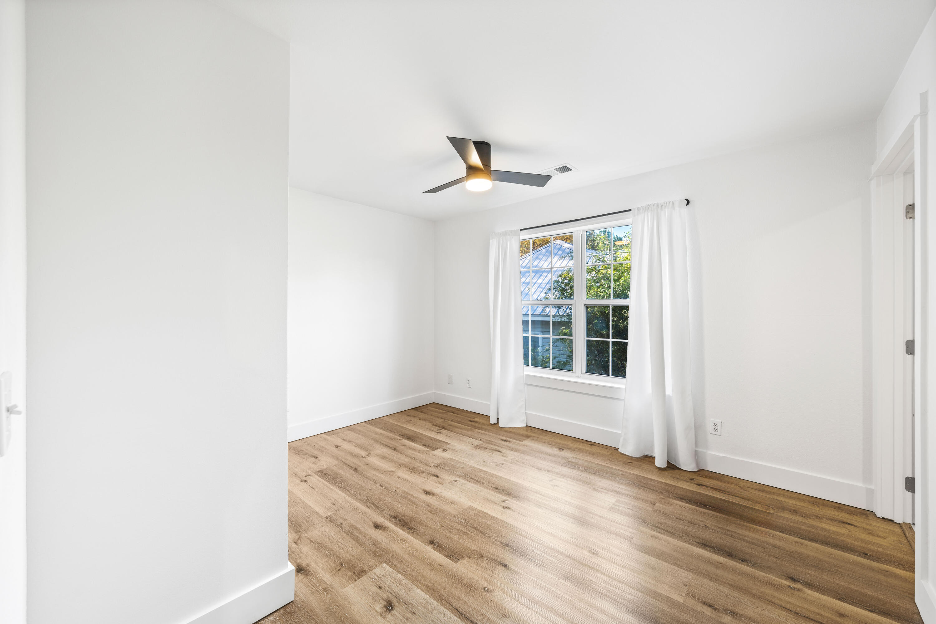 230 Plantation Way Santa Rosa Beach, FL 32459 - Photo 14 of 29 a view of empty room with wooden floor and fan