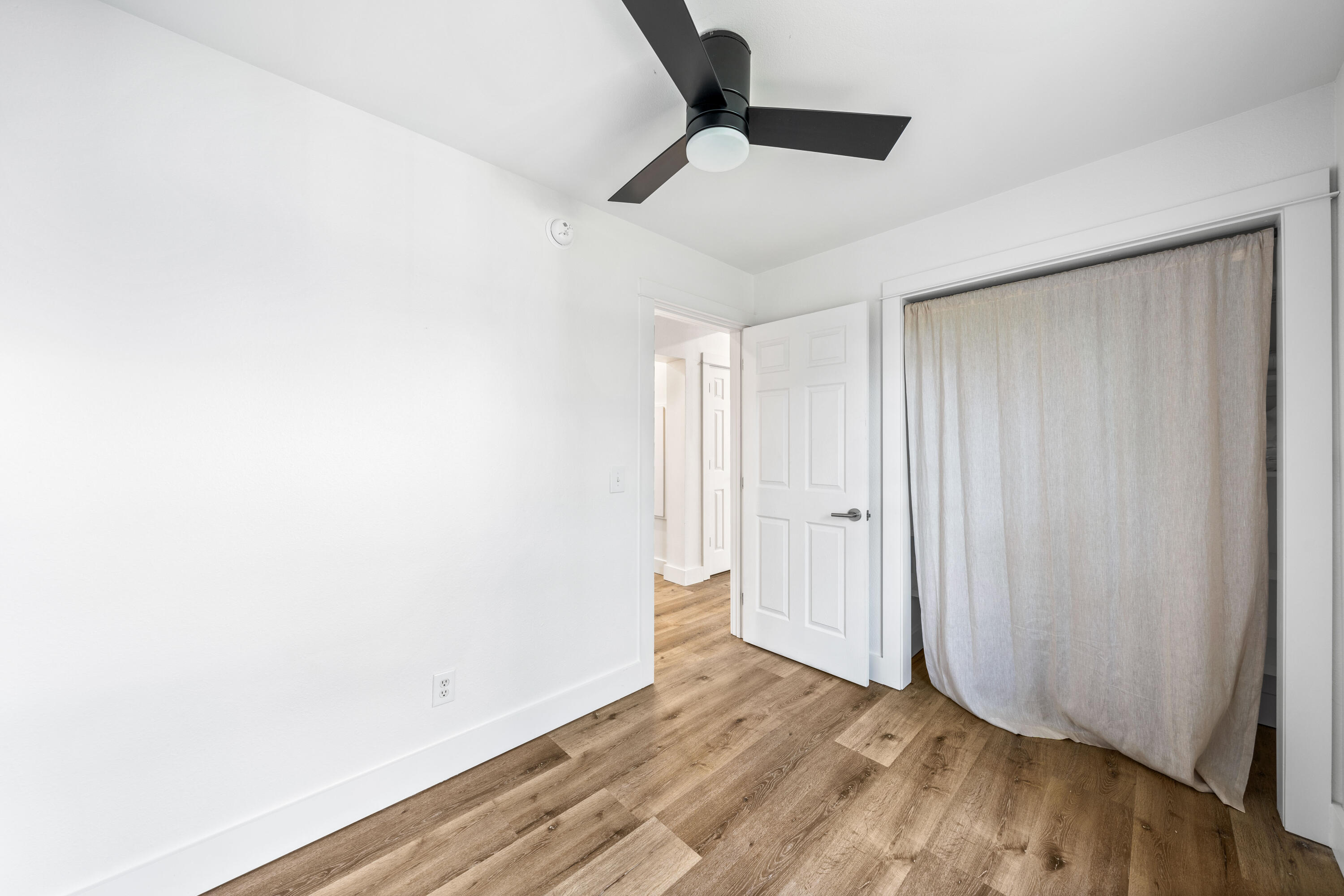 230 Plantation Way Santa Rosa Beach, FL 32459 - Photo 15 of 29 a view of a room with wooden floor and a ceiling fan