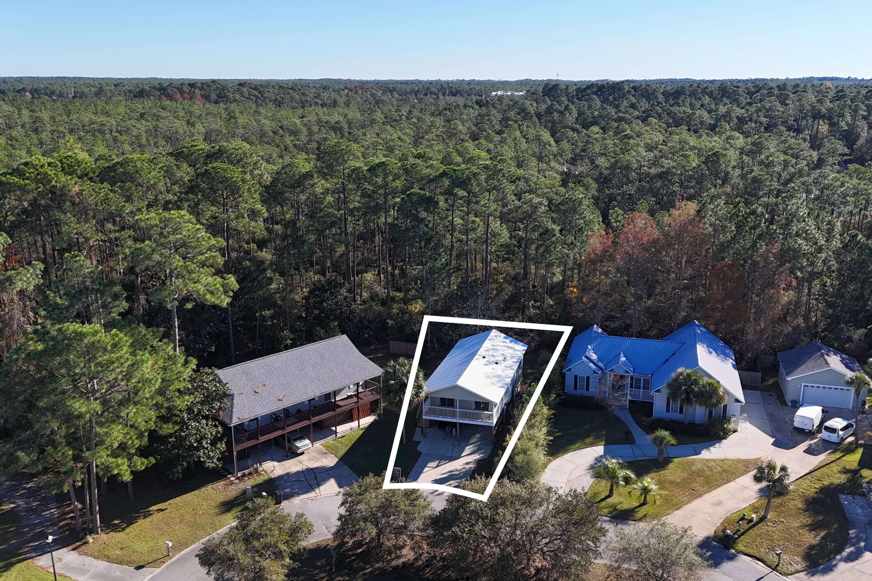 230 Plantation Way Santa Rosa Beach, FL 32459 - Photo 2 of 29 an aerial view of a house with a yard and trees