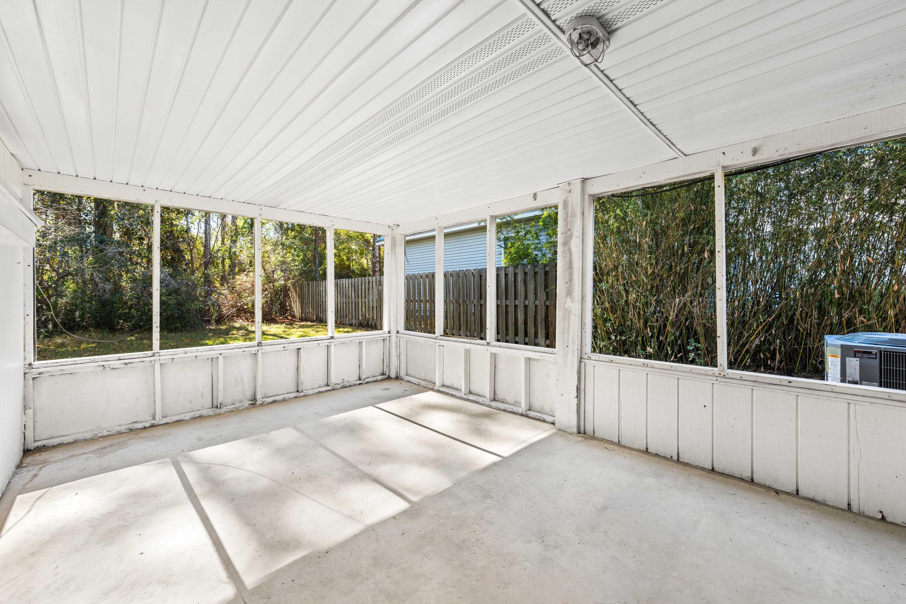 230 Plantation Way Santa Rosa Beach, FL 32459 - Photo 25 of 29 a view of an empty room with wooden floor and a window