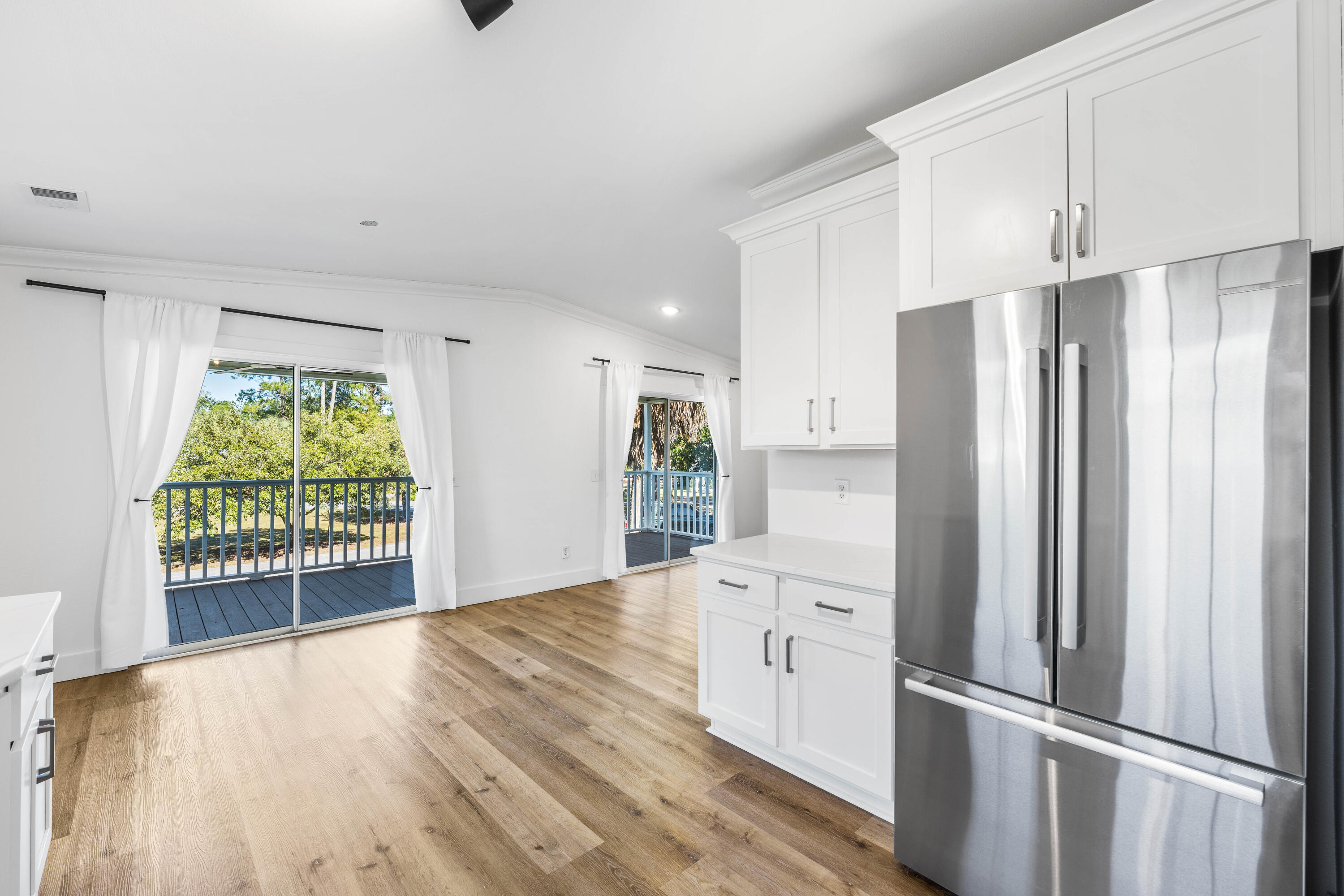 230 Plantation Way Santa Rosa Beach, FL 32459 - Photo 3 of 29 a kitchen with stainless steel appliances a refrigerator and a stove top oven