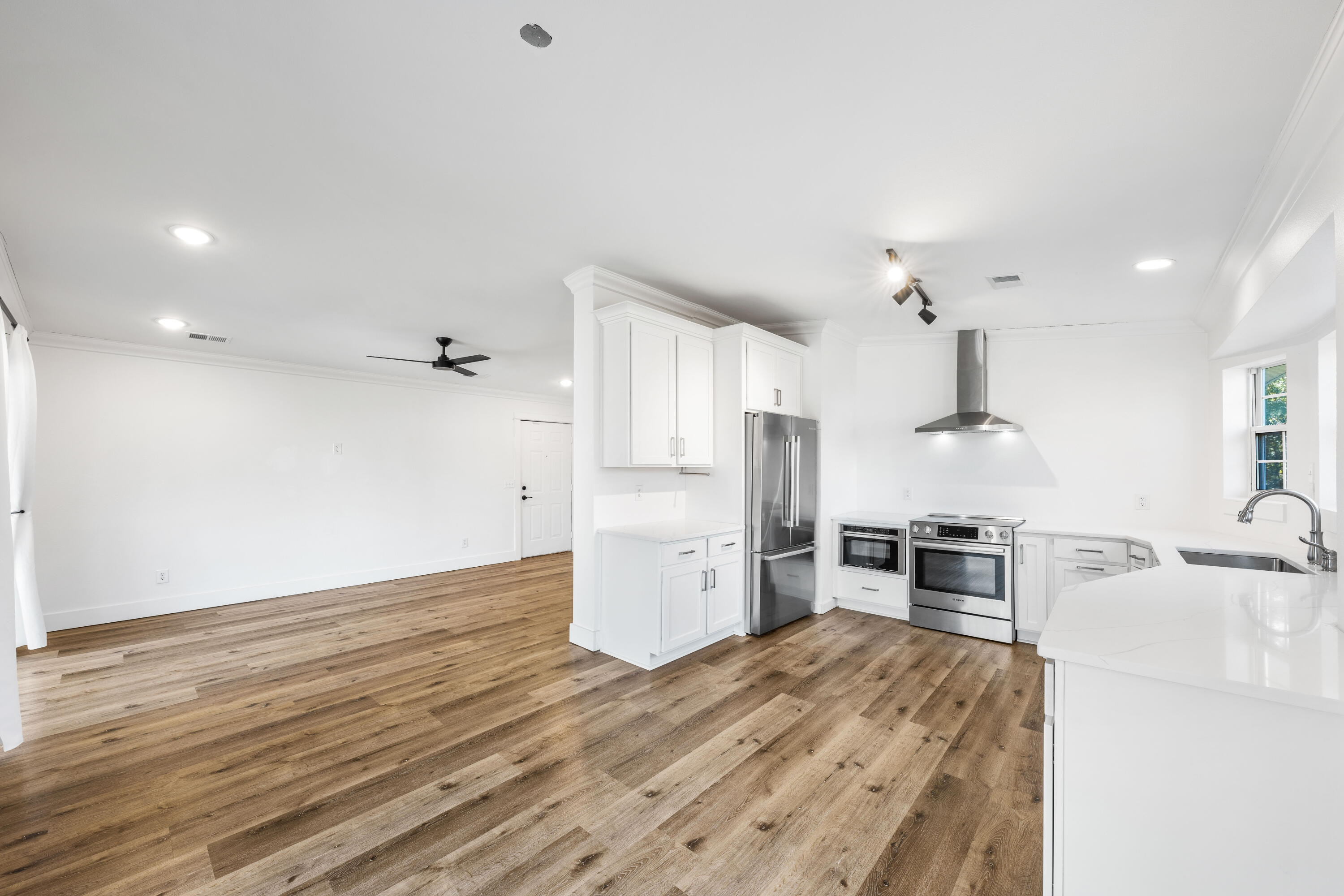 230 Plantation Way Santa Rosa Beach, FL 32459 - Photo 4 of 29 a kitchen with granite countertop a refrigerator and a stove top oven