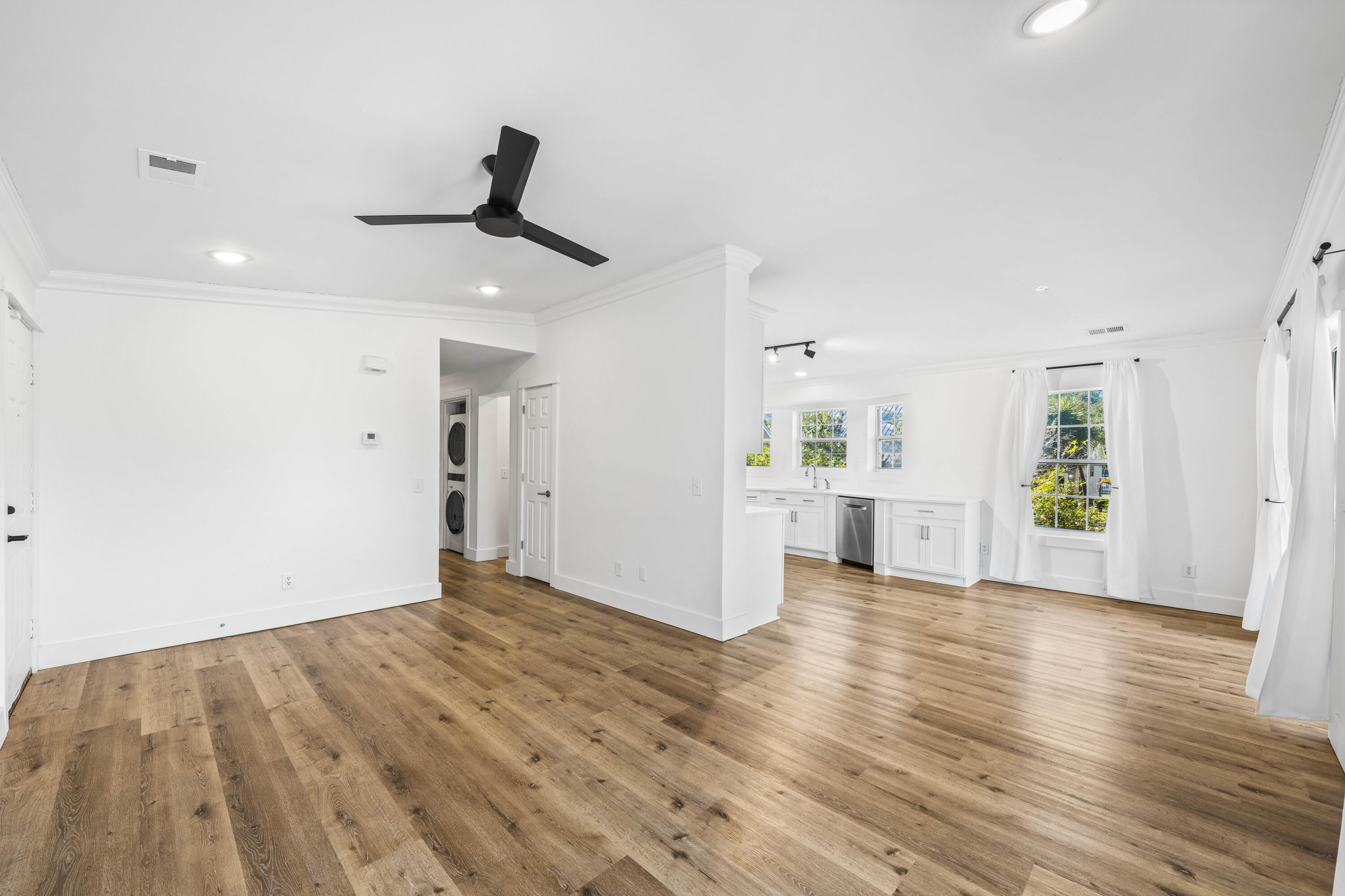 230 Plantation Way Santa Rosa Beach, FL 32459 - Photo 6 of 29 a view of a kitchen with wooden floor and a sink