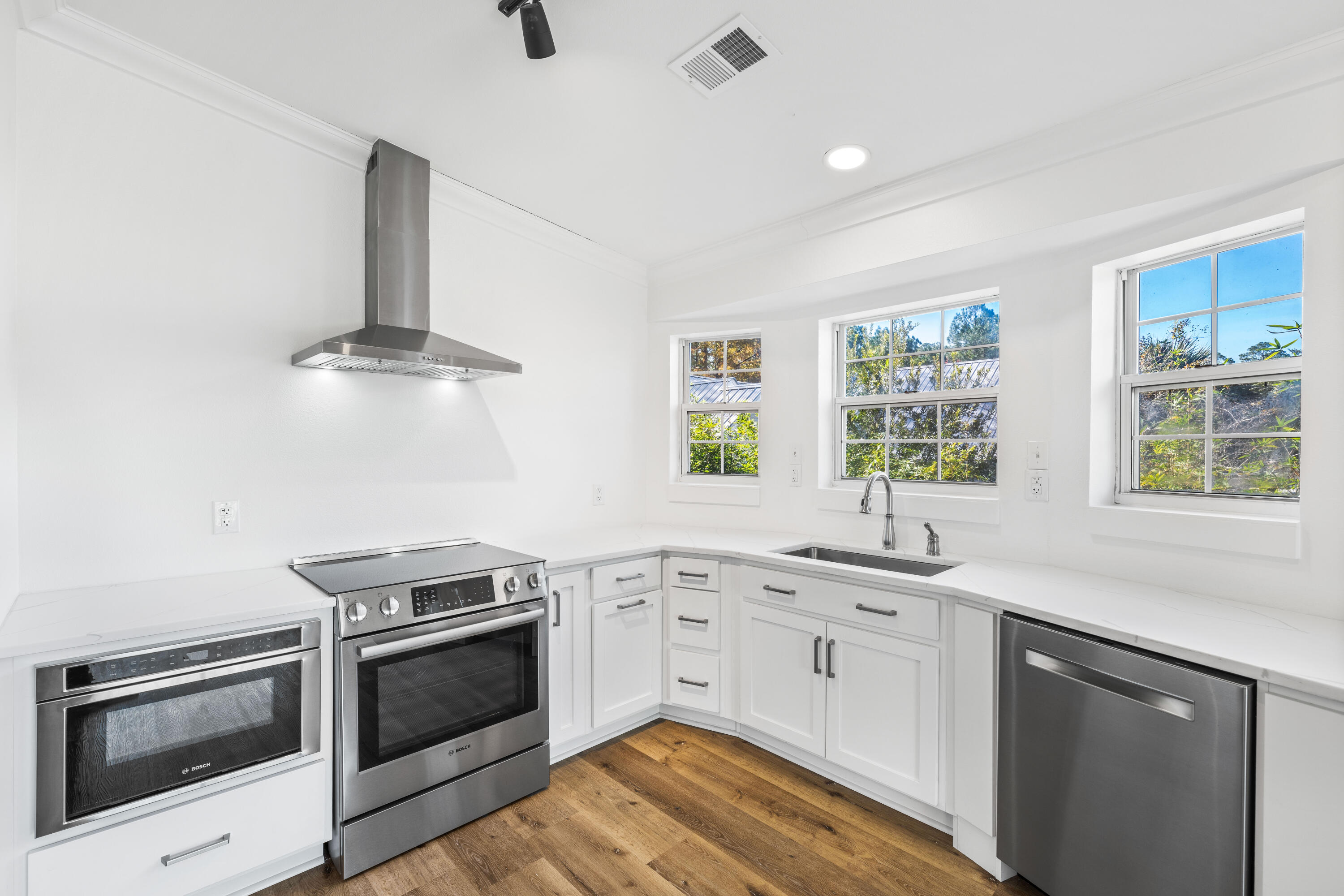 230 Plantation Way Santa Rosa Beach, FL 32459 - Photo 7 of 29 a kitchen with stainless steel appliances white cabinets and a sink
