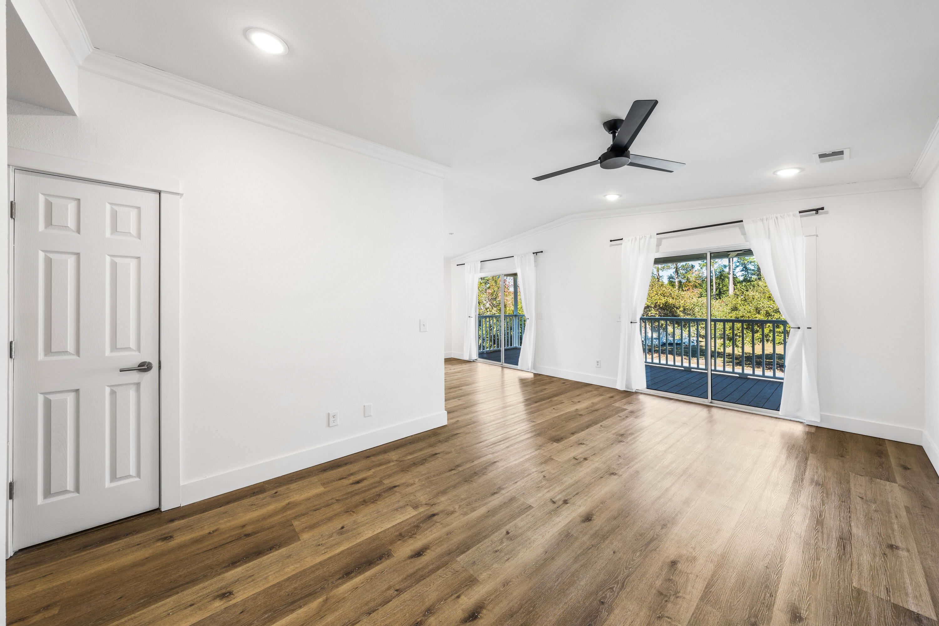 230 Plantation Way Santa Rosa Beach, FL 32459 - Photo 9 of 29 an empty room with wooden floor fan and windows