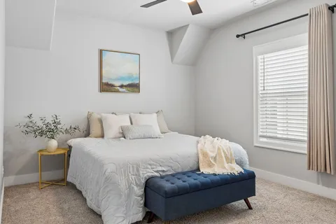 a bedroom with a bed and a couch