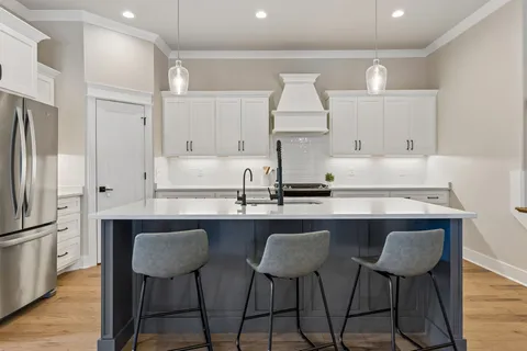a kitchen with stainless steel appliances a sink and a refrigerator