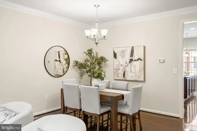 a view of a dining room with furniture and a potted plant
