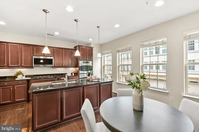 a bathroom with a granite countertop sink a bathtub and shower
