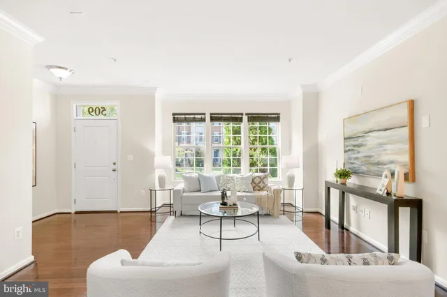 a kitchen with stainless steel appliances granite countertop a stove top oven a sink dishwasher a dining table and chairs with wooden floor