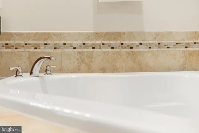 a kitchen with stainless steel appliances granite countertop a refrigerator a stove and a sink