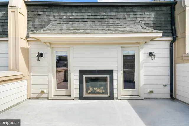 a living room with furniture and floor to ceiling windows