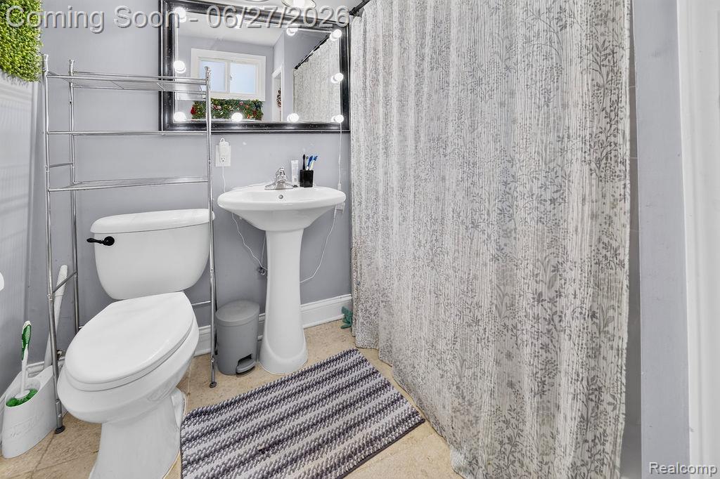 7715 Beech Daly Road Taylor, MI 48180 - Photo 17 of 21 Bathroom featuring a pedestal sink, toilet, and vanity mirror with integrated lighting