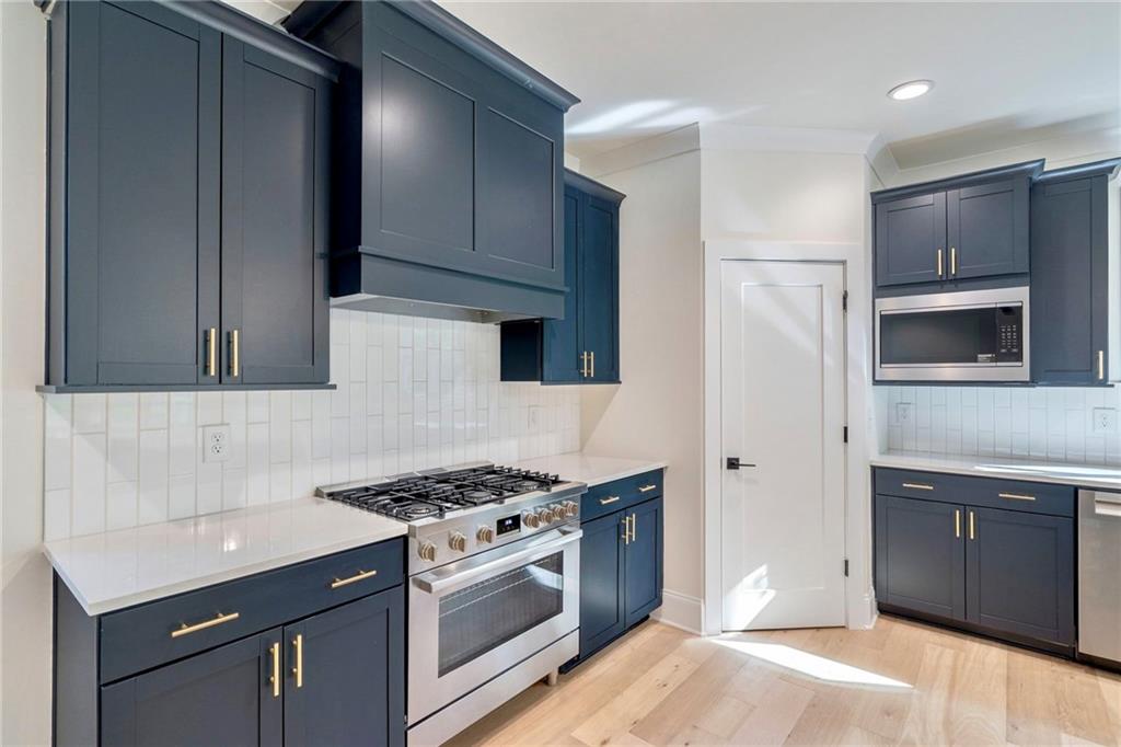 1709 Eastside Parc Street Atlanta, GA 30316 - Photo 15 of 38 a kitchen with stainless steel appliances a sink dishwasher stove and refrigerator