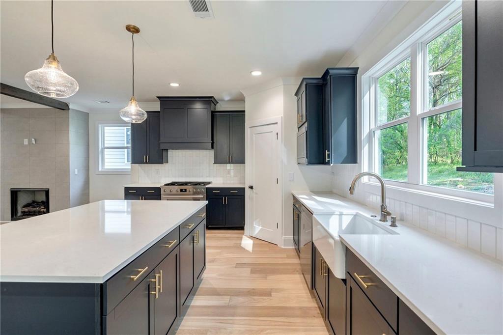 1709 Eastside Parc Street Atlanta, GA 30316 - Photo 16 of 38 a kitchen with a sink stove and wooden floor